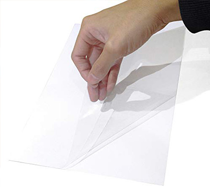 What types of adhesives are used in cold laminating film for documents and posters?